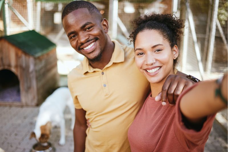 casal a tirar uma fotografia com o seu cão